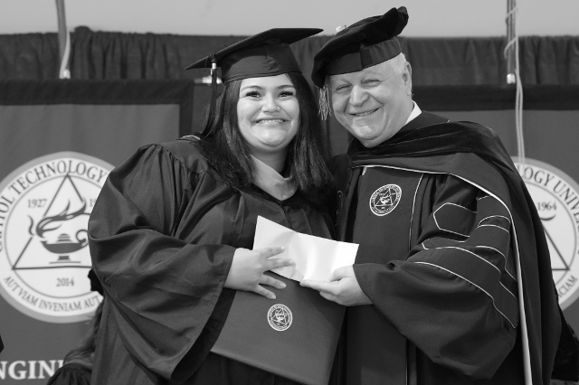 Courtesy Photo Dr. Kam Ghaffarian posing with graduate.